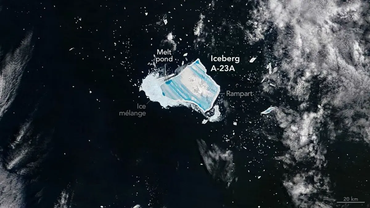 NASA satellite image of Antarctic iceberg A-23A with blue meltwater ponds and fractures, observed in 2025.
