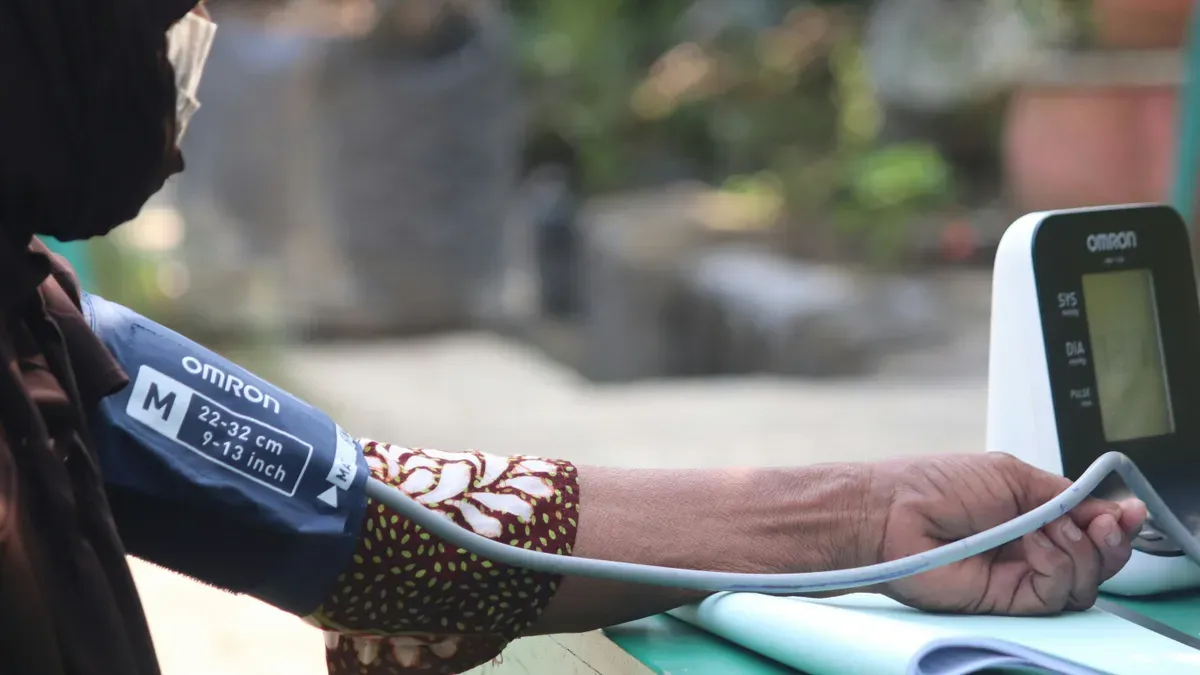 A loaf of bread and a package of processed food with a salt shaker beside them, symbolizing sodium reduction efforts in public health.