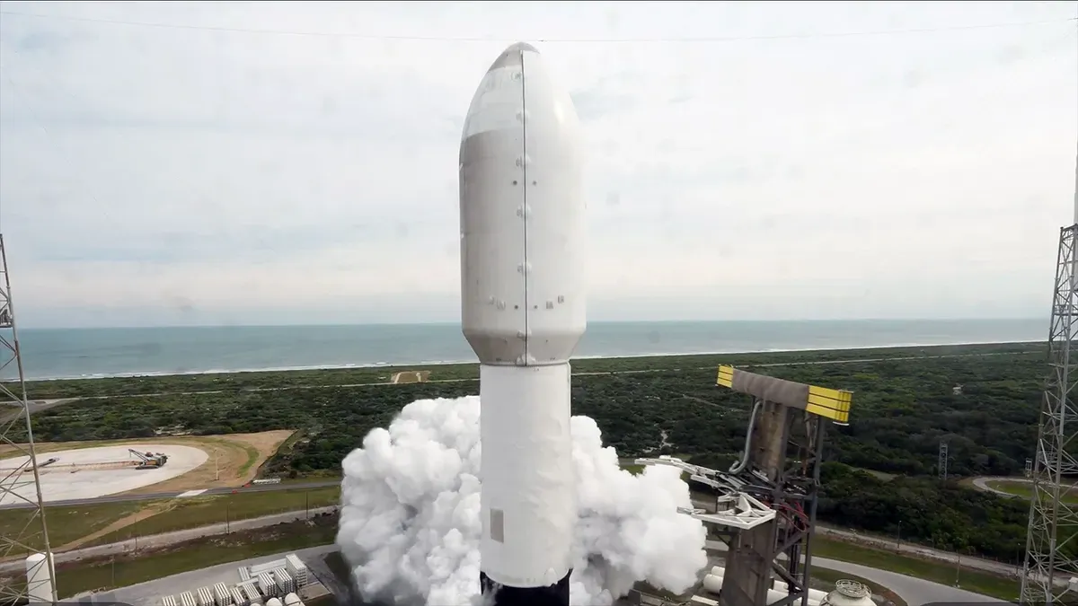 Falcon 9 rocket launches from Cape Canaveral with Starlink satellites, first stage booster descending toward droneship landing in the Atlantic Ocean.